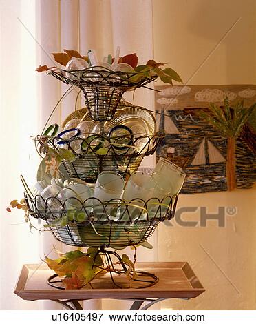 Close-up of three-tiered wirework basket storing glasses View Large Photo Image Stock Photo - Close-up of three-tiered wirework basket storing glasses. Fotosearch