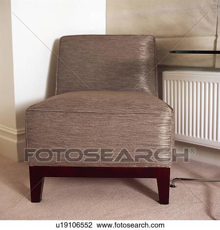 Stock Image - Close up of upholstered beige silk chair . Fotosearch