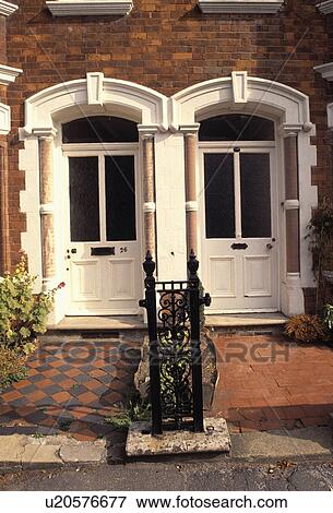 Close-up of white front doors of Edwardian semi-detached town houses View Large Photo Image Stock Photo - Close-up of white front doors of Edwardian semi-detached town houses. Fotosearch