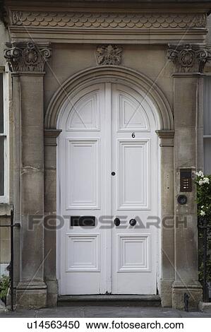 Stock Image - Close-up of white Georgian double front doors. Fotosearch