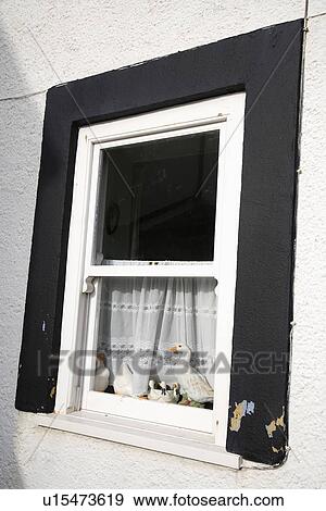 Stock Photo - Close up of white sash window with black frame. Fotosearch