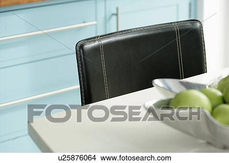Close-up of white table with black leather chair View Large Photo Image Picture - Close-up of white table with black leather chair. Fotosearch