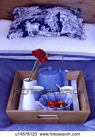 Close-up of wooden tray with blue teapot and cups on bed with blue linen and blue+white floral pillow View Large Photo Image Stock Image - Close-up of wooden tray with blue teapot and cups on bed with blue linen and blue+white floral pillow. Fotosearch