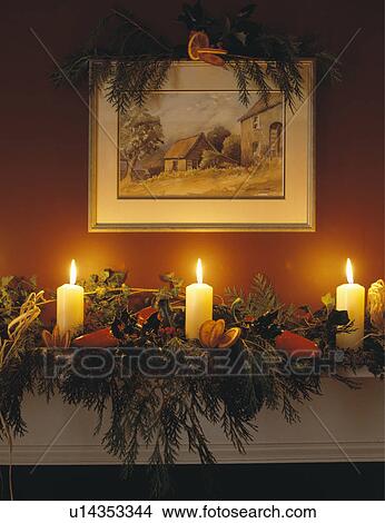 Closeup Of Candles And Decorations Over Fireplace With Painting