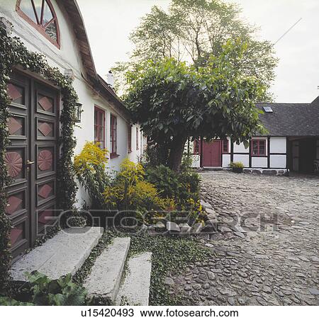 Cobbled courtyard in front of traditional country house in Germany View Large Photo Image Stock Image - Cobbled courtyard in front of traditional country house in Germany. Fotosearch