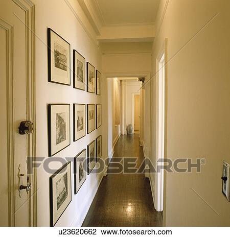 Collection of black+white pictures on wall of narrow modern white hall corridor with grey floor View Large Photo Image Stock Image - Collection of black+white pictures on wall of narrow modern white hall corridor with grey floor. Fotosearch