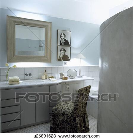 Stock Image - Contemporary, well lit pale blue and white bathroom. Fotosearch