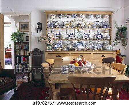 Country diningroom with pine table and chairs and collection of ceramic plates on pine dresser View Large Photo Image Stock Photo - Country diningroom with pine table and chairs and collection of ceramic plates on pine dresser. Fotosearch