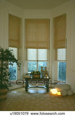 Stock Photo - Cream blinds in traditional living room. Fotosearch