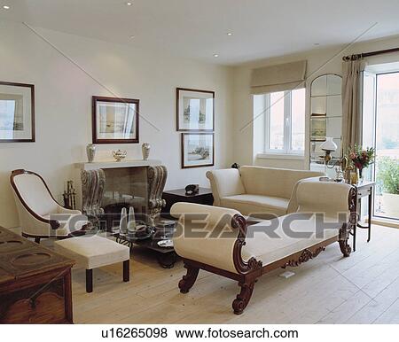 Stock Photo - Cream chaiselongue in modern cream living room with limed floorboards. Fotosearch