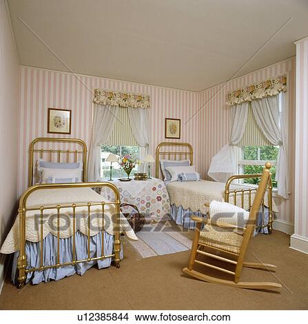 Cream Quilts And Blue Valances On Ilt Twin Beds In Bedroom With Peach Striped Wallpaper And Pine Rockingchair Picture