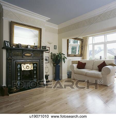 Cream sofa and laminated wood floor in lneutral ivingroom with pastel blue ceiling View Large Photo Image Stock Image - Cream sofa and laminated wood floor in lneutral ivingroom with pastel blue ceiling. Fotosearch