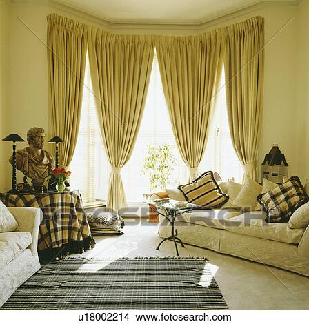 Stock Photo Of Cream Sofa And Yellow Curtains In Traditional Living Cream Sofa And Yellow Curtains In Traditional Living Room