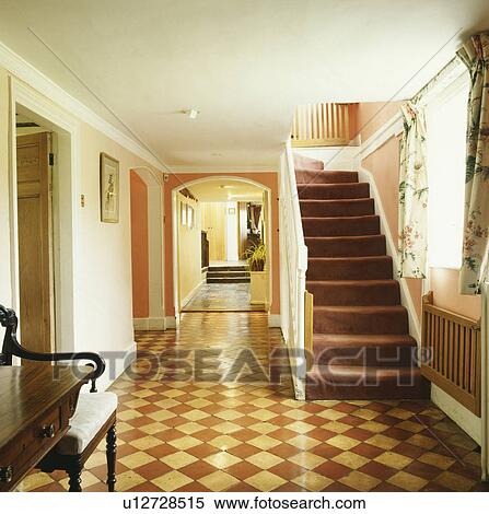 Cream+brown tiled floor in country hall with safety gate at the bottom of staircase with brown carpet View Large Photo Image Stock Photography - Cream+brown tiled floor in country hall with safety gate at the bottom of staircase with brown carpet. Fotosearch
