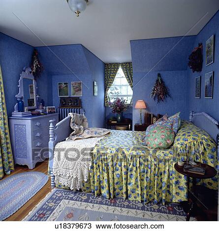 Crochet throw and yellow+blue bedlinen in bright blue attic bedroom with painted blue chest-of-drawers View Large Photo Image Stock Image - Crochet throw and yellow+blue bedlinen in bright blue attic bedroom with painted blue chest-of-drawers. Fotosearch