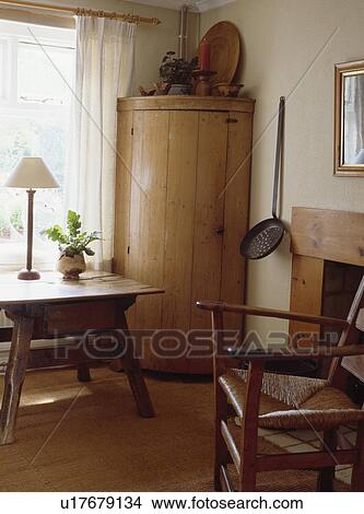 Curved Antique Pine Corner Cupboard In Neutral Dining Room With Rush Seated Chair And Small Antique Table Picture U17679134 Fotosearch