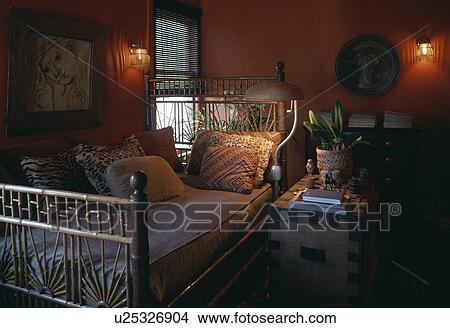 Cushions on cane sofa in red living room View Large Photo Image Picture - Cushions on cane sofa in red living room. Fotosearch
