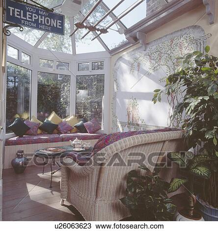 Cushions on windowseat and wicker sofa in conservatory extension View Large Photo Image Stock Image - Cushions on windowseat and wicker sofa in conservatory extension. Fotosearch