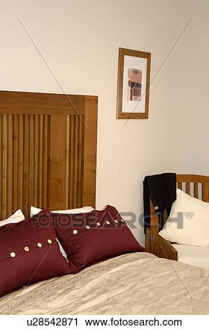 Dark brown cushions on bed with wooden headboard and cream cover View Large Photo Image Stock Image - Dark brown cushions on bed with wooden headboard and cream cover. Fotosearch