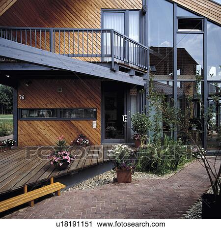 Decking in front of modern wood-clad town house View Large Photo Image Stock Image - Decking in front of modern wood-clad town house. Fotosearch