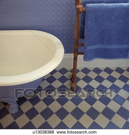 Detail of blue and white bathroom with chequered floor and towel rail.  View Large Photo Image Stock Photo - Detail of blue and white bathroom with chequered floor and towel rail. . Fotosearch