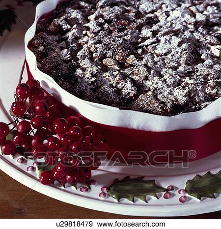 Detail of dark fruit cake dusted with icing sugar and tied with a red ribbon View Large Photo Image Stock Photo - Detail of dark fruit cake dusted with icing sugar and tied with a red ribbon. Fotosearch