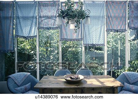 Different patterned pastel blue blinds on windows of conservatory dining room with view of the garden View Large Photo Image Stock Photograph - Different patterned pastel blue blinds on windows of conservatory dining room with view of the garden. Fotosearch