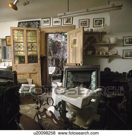 Doors with stained glass panels and fireplace and basins in reclamation showroom View Large Photo Image Stock Photo - Doors with stained glass panels and fireplace and basins in reclamation showroom . Fotosearch