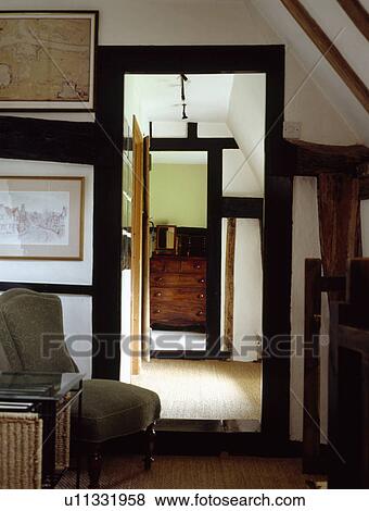 Stock Photo - Doorway on cottage attic landing with black beams. Fotosearch