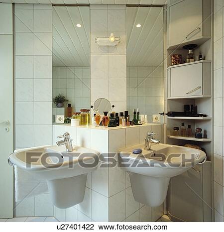Double white units set at right angles below mirrors in modern white bathroom View Large Photo Image Stock Image - Double white units set at right angles below mirrors in modern white bathroom. Fotosearch