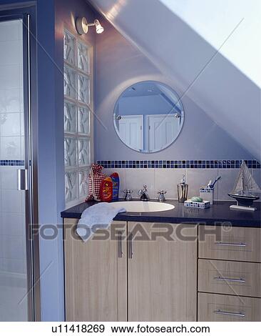 Stock Photo - En suite area in a blue attic bedroom. Fotosearch