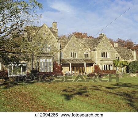 Exterior of large stone detached country house with lawn. View Large Photo Image Stock Photograph - Exterior of large stone detached country house with lawn.. Fotosearch