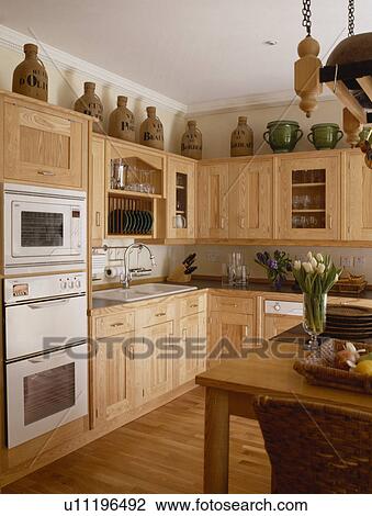 Eye-level built-in white double oven in Smallbone wooden kitchen View Large Photo Image Stock Image - Eye-level built-in white double oven in Smallbone wooden kitchen . Fotosearch