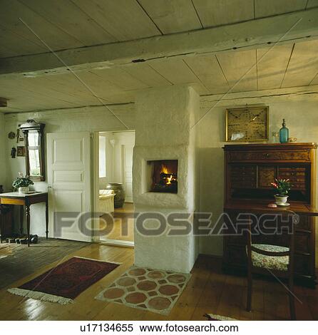 Stock Photography - Fireplace in rustic wall in white Scandinavian country living room. Fotosearch