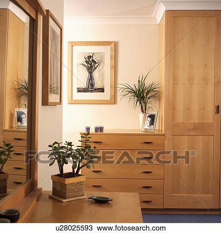 Fitted pine cupboards and chest-of-drawers in bedroom View Large Photo Image Stock Image - Fitted pine cupboards and chest-of-drawers in bedroom . Fotosearch
