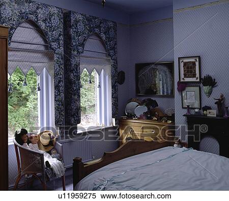 Floral Lambrequins And White Blinds Above Windows In Country Bedroom With Blue Patterned Wallpaper Stock Photography