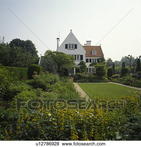 Flower borders and mown lawn in large garden in front of traditional country house in summer View Large Photo Image Stock Photo - Flower borders and mown lawn in large garden in front of traditional country house in summer. Fotosearch
