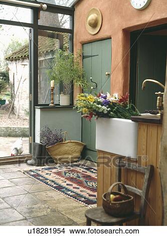 Flowers in white ceramic sink in kitchen extension View Large Photo Image Picture - Flowers in white ceramic sink in kitchen extension. Fotosearch