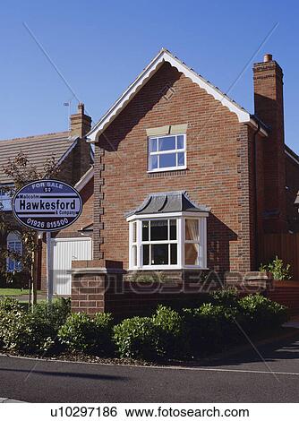 For Sale sign in front of traditional new-build house View Large Photo Image Stock Photograph - For Sale sign in front of traditional new-build house. Fotosearch