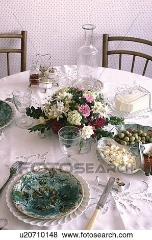 French flower arrangement in centre of table with place settings on white lace cloth View Large Photo Image Stock Photo - French flower arrangement in centre of table with place settings on white lace cloth. Fotosearch