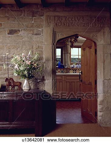 fresh flowers on antique carved wooden chest in hall with stone walls and open door below 17th century carving View Large Photo Image Stock Image - fresh flowers on antique carved wooden chest in hall with stone walls and open door below 17th century carving. Fotosearch