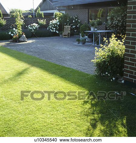Furniture on patio in town garden in summer View Large Photo Image Stock Image - Furniture on patio in town garden in summer. Fotosearch