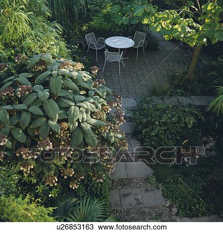 Furniture on patio in town garden in summer View Large Photo Image Stock Image - Furniture on patio in town garden in summer. Fotosearch