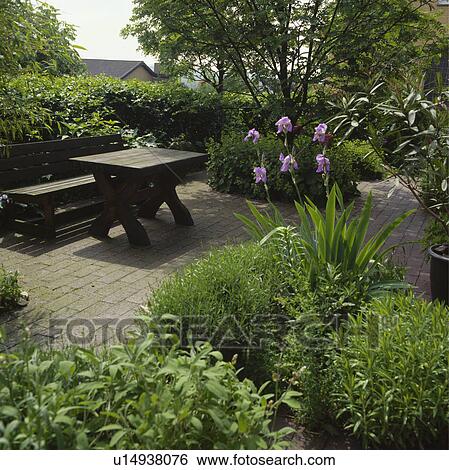Stock Photograph - Furniture on patio in town garden in summer. Fotosearch