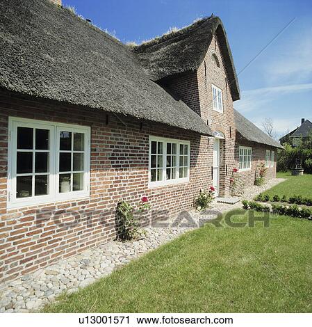 Stock Image - German thatched single storey country house.. Fotosearch