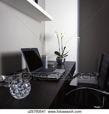 Glass paperweight and laptop computer on black leather desk in modern home office View Large Photo Image Stock Image - Glass paperweight and laptop computer on black leather desk in modern home office. Fotosearch
