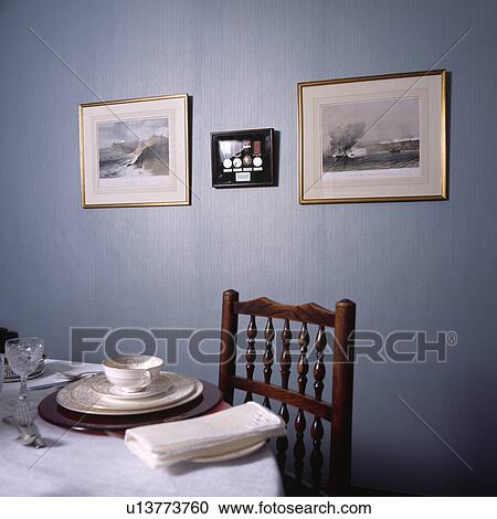 Gold patterned white china with white napkins on table in blue dining room View Large Photo Image Stock Image - Gold patterned white china with white napkins on table in blue dining room . Fotosearch