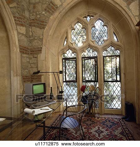 Gothic window in home-office in converted church View Large Photo Image Stock Photography - Gothic window in home-office in converted church. Fotosearch