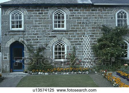 Gothic windows in terraced stone cottage with small front garden View Large Photo Image Stock Photography - Gothic windows in terraced stone cottage with small front garden. Fotosearch
