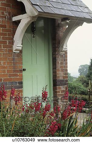 Green traditional cottage door with slate porch View Large Photo Image Stock Photo - Green traditional cottage door with slate porch. Fotosearch